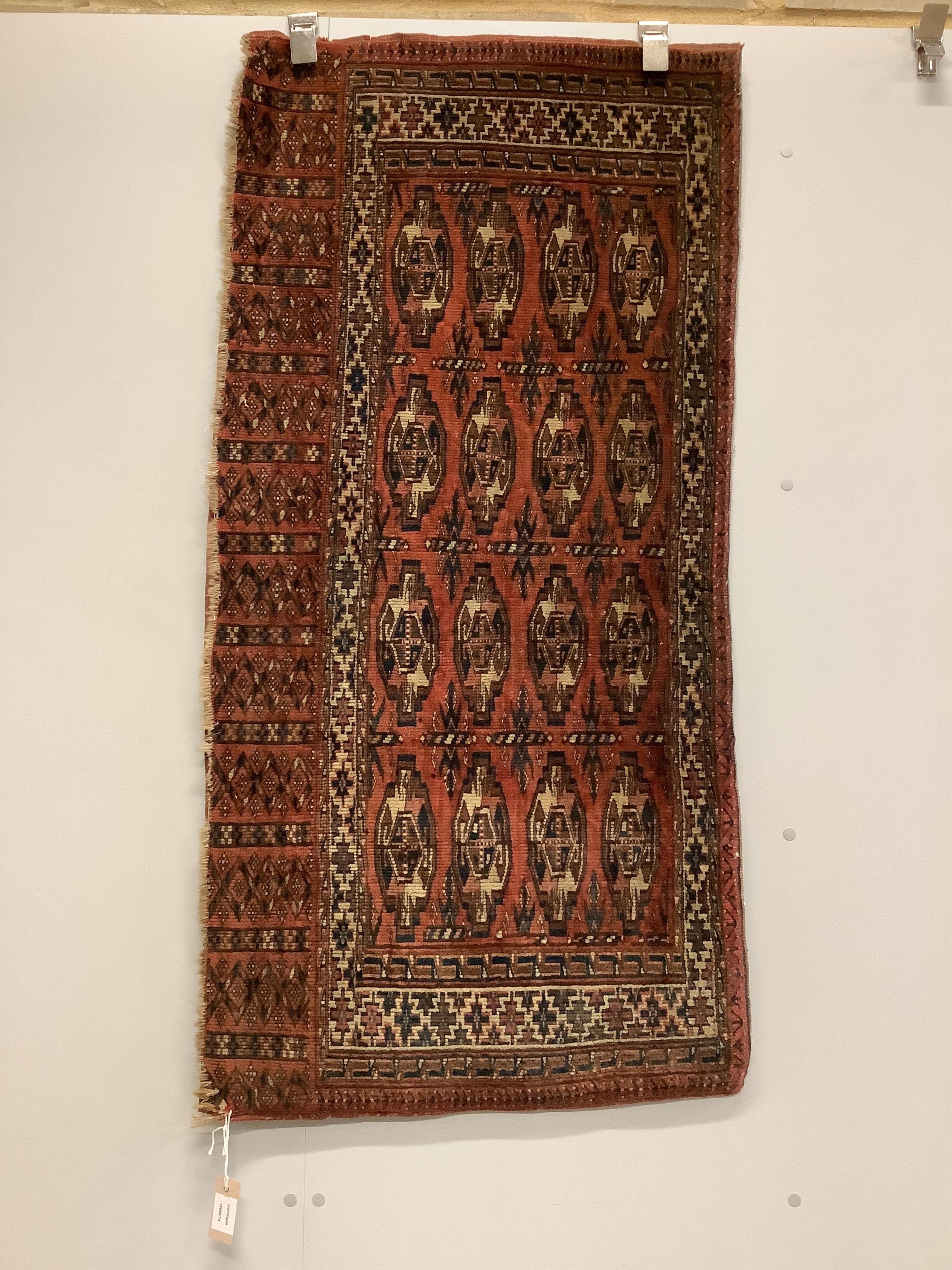 A Bokhara Tekke Turkoman red ground saddle bag rug, 134 x 55cm. Condition - fair